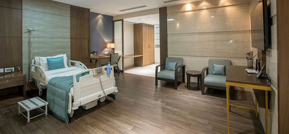 Private patient room with attendant seating at Apollo Hospitals, Mumbai
